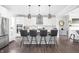 Modern kitchen with white cabinets, stainless steel appliances, a central island with seating, and pendant lighting at 10262 Rieslaner Cir, Zionsville, IN 46077