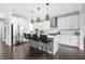 Bright, modern kitchen with an island, bar stools, stainless steel appliances, and ample counter space at 10262 Rieslaner Cir, Zionsville, IN 46077