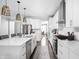 Modern kitchen with white cabinets, stainless steel appliances, an island with a sink, and pendant lighting at 10262 Rieslaner Cir, Zionsville, IN 46077