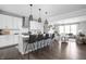 Open-concept kitchen featuring an island with barstool seating, pendant lighting, and stainless steel appliances at 10262 Rieslaner Cir, Zionsville, IN 46077