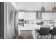 Well-equipped kitchen boasts stainless steel appliances, white cabinetry, and an island with barstool seating at 10262 Rieslaner Cir, Zionsville, IN 46077
