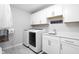 Well-organized laundry room with white cabinets, sink, washer, and dryer at 10262 Rieslaner Cir, Zionsville, IN 46077