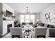 Bright living room features a fireplace, hardwood floors, neutral colors, and modern stylish light fixture at 10262 Rieslaner Cir, Zionsville, IN 46077