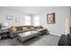 Bright living room with carpeted floors, a gray sofa with yellow pillows, and a grey coffee table at 10262 Rieslaner Cir, Zionsville, IN 46077