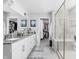 A spacious main bathroom features double sinks, a glass shower, tile floors, and a walk-in closet at 10262 Rieslaner Cir, Zionsville, IN 46077