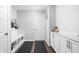 Mud room with white cabinets and storage space for shoes and coats, features dark floor mats at 10262 Rieslaner Cir, Zionsville, IN 46077
