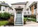 Backyard features a raised deck, brick exterior and a stone patio with lush greenery for added privacy at 1037 Deer Lake Dr, Carmel, IN 46032