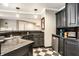 Elegant wet bar with dark cabinetry, granite countertops, and ample storage space in finished basement at 1037 Deer Lake Dr, Carmel, IN 46032