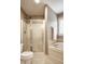 Bathroom features a tiled shower with glass doors and a soaking tub, offering a spa-like experience at 1037 Deer Lake Dr, Carmel, IN 46032