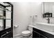 Modern powder room featuring a vessel sink, black cabinets, and contemporary fixtures at 1037 Deer Lake Dr, Carmel, IN 46032