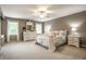 Spacious bedroom with a white metal bed frame, ceiling fan, dresser, and two large windows providing natural light at 1037 Deer Lake Dr, Carmel, IN 46032