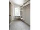 Walk-in closet with shelves, towel storage, and natural light from a window, perfect for storage and organization at 1037 Deer Lake Dr, Carmel, IN 46032