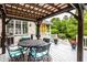 Outdoor deck features covered dining area with an exterior brick wall and backyard access at 1037 Deer Lake Dr, Carmel, IN 46032