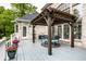 Outdoor deck features covered dining area with an exterior brick wall and access to the backyard at 1037 Deer Lake Dr, Carmel, IN 46032