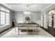 Bright dining room boasting elegant wallpaper, a chandelier, and large windows at 1037 Deer Lake Dr, Carmel, IN 46032