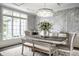 Cozy dining room with a large window, chandelier, table, bench and neutral color palette at 1037 Deer Lake Dr, Carmel, IN 46032