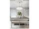 Charming dining room featuring a large chandelier, a wood table, and elegant decor at 1037 Deer Lake Dr, Carmel, IN 46032