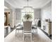 Formal dining room featuring a chandelier, patterned wallpaper, and lots of seating at 1037 Deer Lake Dr, Carmel, IN 46032