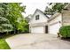 Well-maintained home exterior with three-car garage, basketball hoop, and lush landscaping enhancing curb appeal at 1037 Deer Lake Dr, Carmel, IN 46032