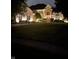 Beautiful home exterior illuminated at night, showcasing manicured landscaping and inviting facade at 1037 Deer Lake Dr, Carmel, IN 46032