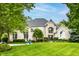 Stunning exterior view of a brick home with a manicured lawn and beautiful landscaping at 1037 Deer Lake Dr, Carmel, IN 46032