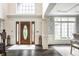 Elegant foyer featuring a stained glass entry door, hardwood floors, and wainscotting at 1037 Deer Lake Dr, Carmel, IN 46032