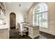 Vaulted home office with custom cabinets and a large arched window providing natural light at 1037 Deer Lake Dr, Carmel, IN 46032