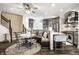 Bright kitchen with granite counters, stainless appliances, seated breakfast bar, and adjacent breakfast nook at 1037 Deer Lake Dr, Carmel, IN 46032