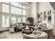 Bright living area with large windows, a circular chandelier, and comfortable seating at 1037 Deer Lake Dr, Carmel, IN 46032