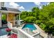 Inviting pool area with deck, mature landscaping, and outdoor living space for relaxation and entertainment at 1037 Deer Lake Dr, Carmel, IN 46032