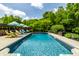 Backyard pool features lounge seating and landscaped patio, perfect for relaxation and outdoor enjoyment at 1037 Deer Lake Dr, Carmel, IN 46032