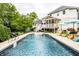 Backyard oasis showcasing a sparkling pool, lush greenery, and the home's elegant exterior with a spacious outdoor area at 1037 Deer Lake Dr, Carmel, IN 46032