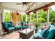Inviting screened porch with comfortable seating, ceiling fan, and views of the lush backyard at 1037 Deer Lake Dr, Carmel, IN 46032