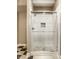 Modern shower with glass enclosure and stone accents, seamlessly blending style and functionality at 1037 Deer Lake Dr, Carmel, IN 46032