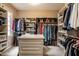 Spacious walk-in closet featuring clothing racks, shelving, drawers, and a center island at 1037 Deer Lake Dr, Carmel, IN 46032