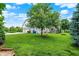 Spacious backyard with lush lawn and mature shade tree with swing at 10587 Proposal Pointe Way, Fishers, IN 46040
