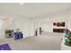 Spacious basement features carpet, white walls, kitchenette, and ample room for activities at 10587 Proposal Pointe Way, Fishers, IN 46040