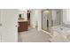 Bright bathroom featuring a soaking tub, a vanity with dual sinks, a glass enclosed shower, and tiled floor at 10587 Proposal Pointe Way, Fishers, IN 46040