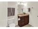 Well-lit bathroom with single sink vanity, framed mirror, and warm brown cabinets at 10587 Proposal Pointe Way, Fishers, IN 46040