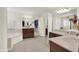 A spacious bathroom featuring dual vanities, a soaking tub, and access to a walk-in closet at 10587 Proposal Pointe Way, Fishers, IN 46040