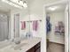 A well-lit bathroom with a vanity, a mirror, and an open closet for ample storage at 10587 Proposal Pointe Way, Fishers, IN 46040