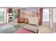 A charming bedroom with two beds, pastel accents, and natural light from the windows at 10587 Proposal Pointe Way, Fishers, IN 46040