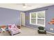 A peaceful purple bedroom featuring a ceiling fan, a window, and cozy decor at 10587 Proposal Pointe Way, Fishers, IN 46040