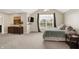 Inviting bedroom with a vaulted ceiling, neutral walls, soft carpet and a large window offering ample sunlight at 10587 Proposal Pointe Way, Fishers, IN 46040