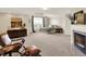 Spacious bedroom with a fireplace, sitting area, and large window offering abundant natural light at 10587 Proposal Pointe Way, Fishers, IN 46040