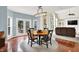 Cozy dining area with hardwood floors, stylish lighting, and a view of the backyard at 10587 Proposal Pointe Way, Fishers, IN 46040