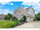 Charming home with a lush front yard and a three-car garage at 10587 Proposal Pointe Way, Fishers, IN 46040