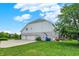 Well-manicured lawn leads up to a 3-car garage, back deck and screened porch at 10587 Proposal Pointe Way, Fishers, IN 46040