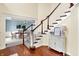 Elegant foyer with hardwood floors, a staircase with white risers and a view to the dining room at 10587 Proposal Pointe Way, Fishers, IN 46040