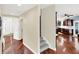 Open foyer with hardwood floors flows into the kitchen with dark cabinets, stainless appliances, and a breakfast bar at 10587 Proposal Pointe Way, Fishers, IN 46040
